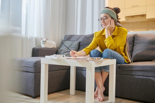 A female artist sitting in the studio with new sketches