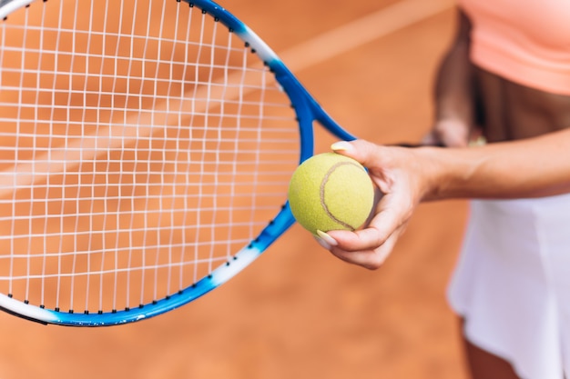 Female athlete hits a tennis ball with a racket