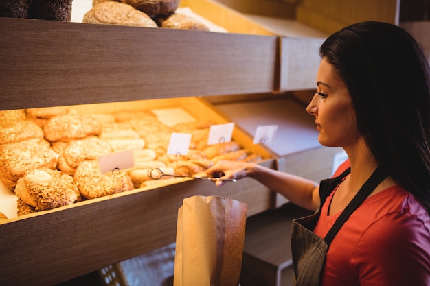 Female baker packing sweet food