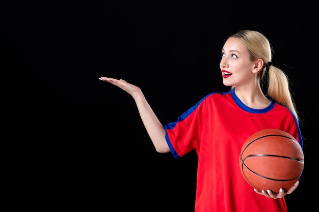 female basketball player in sport clothes with ball on black background game athletes play