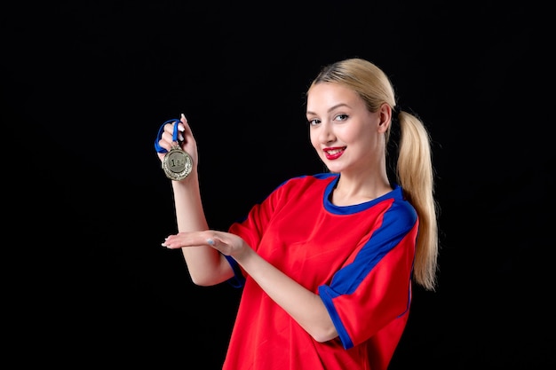 female basketball player with golden medal on black background athlete winner game