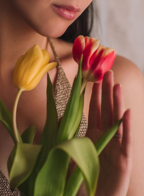 Female body and pink spring flowers tulips Feminine details of beauty and inspiration