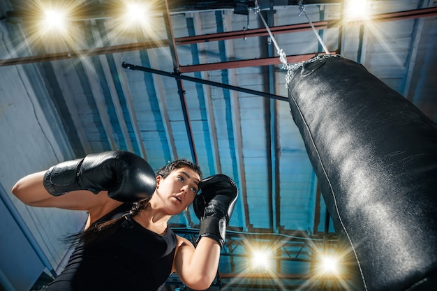 The female boxer and afro american male boxer training box at gym