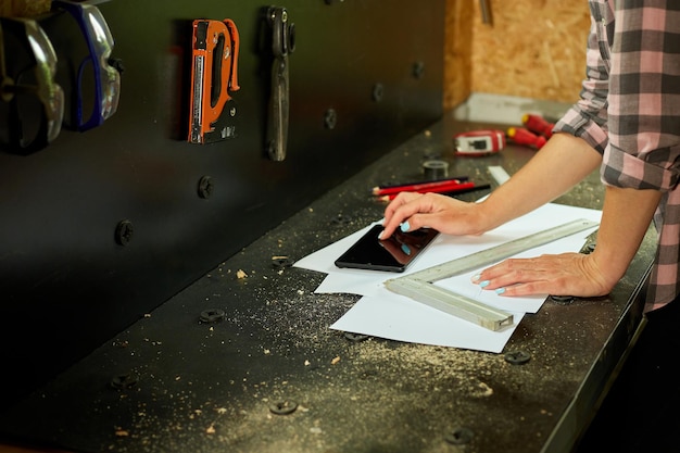 Female business owner using digital tablet in workshop