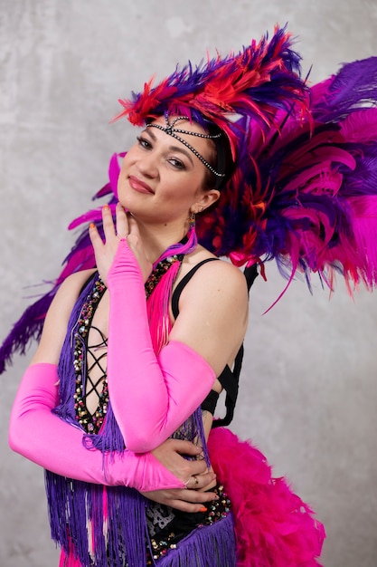 Female cabaret performer posing in feathers costume