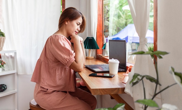 A female at a cafe using a laptop young white woman sitting in a coffee shop busy working