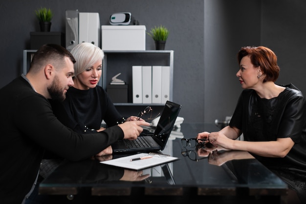 Female candidate sits in front of two young men at interview