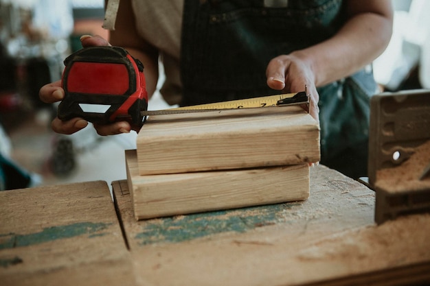 Female carpenter measuring the lumber