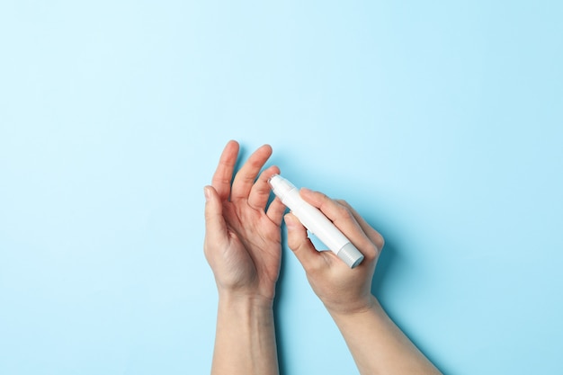 Female checking blood sugar level on blue background