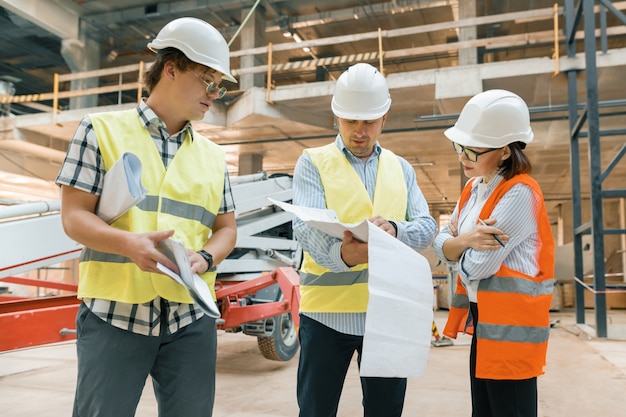 Female construction inspector examining construction site