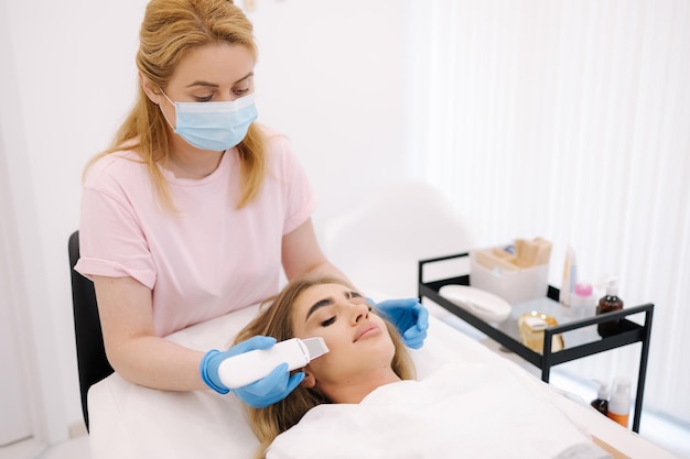 Female at cosmetic beauty spa clinic has facial hardware cosmetology woman making beauty procedures