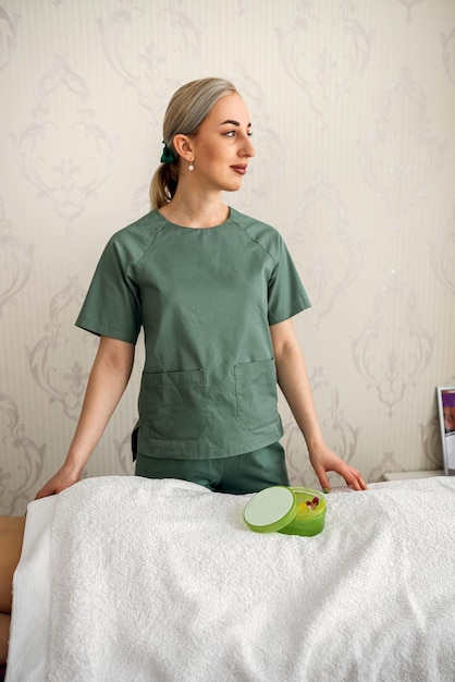 Female cosmetologist standing near her woman client