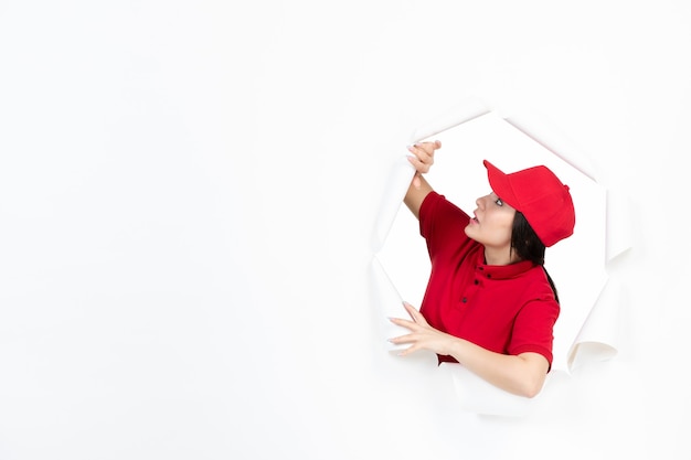 Female courier in red uniform on white