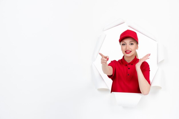 Female courier in red uniform on white