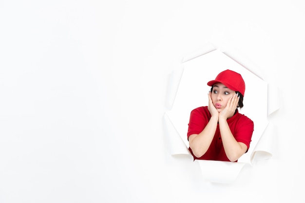 Female courier in red uniform on white