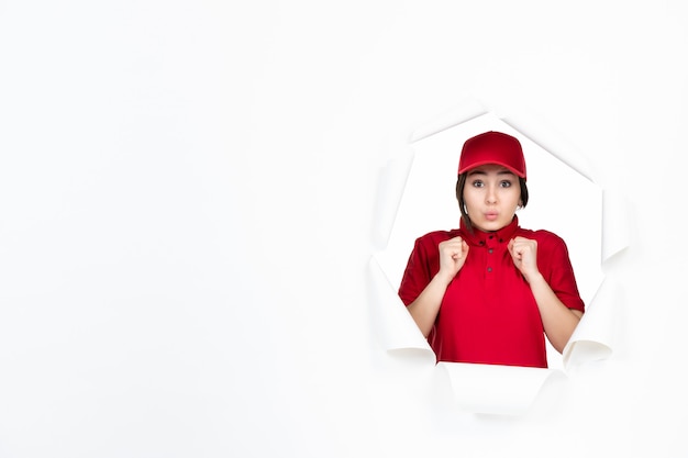 Female courier in red uniform on white