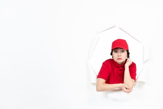 Female courier in red uniform on white