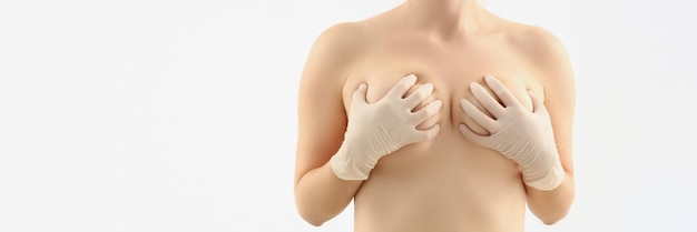 Female cover breasts with hands natural size of boobs white background