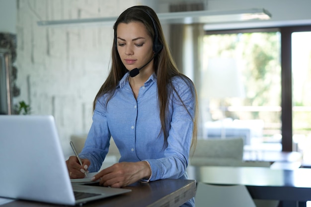 Female customer support operator with headset and smiling