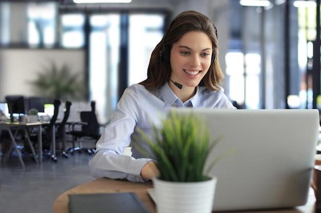 Female customer support operator with headset and smiling