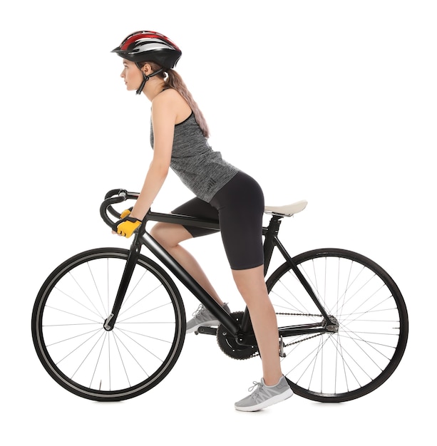 Female cyclist riding bicycle on white