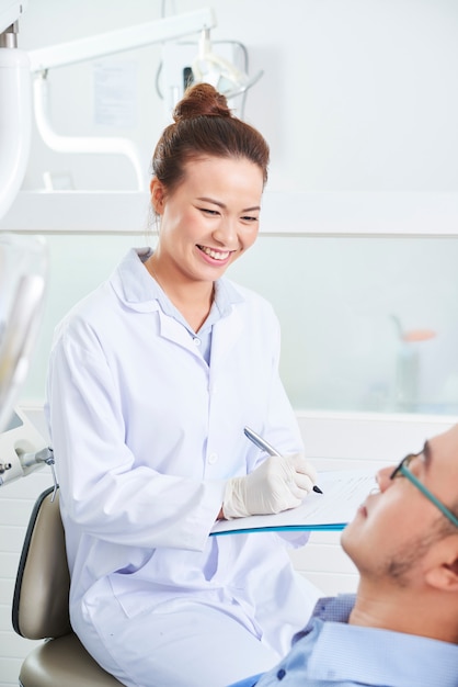 Female dentist consulting with patient