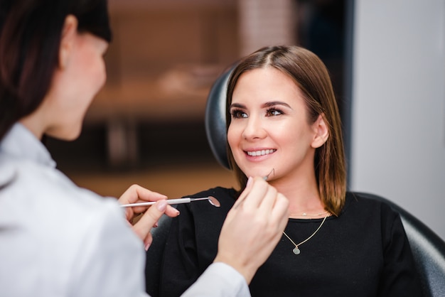 Female dentist with female patient during dental checkup.