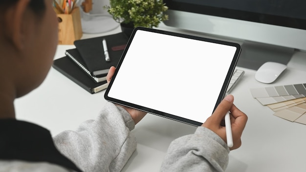 A female designer working with tablet at her workspace