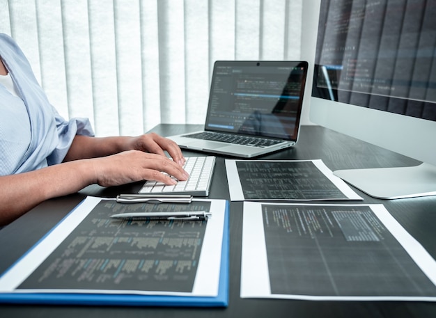 Female Developer programmer working on coding program software computer, Writing website and development database technology in office.