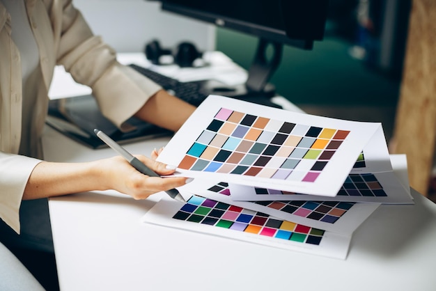 Photo female digital designer looking at swatches at an office