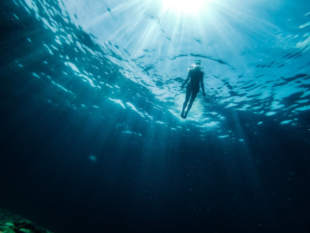 Female diver emerge from the sea