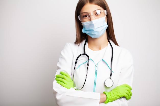 Female doctor in clinic wears personal protective equipment