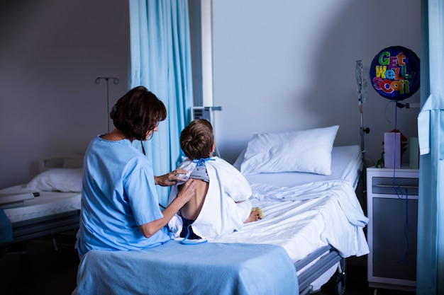 Female doctor examining patient with stethoscope