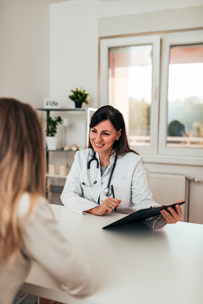 Female doctor and female patient talking about test results.