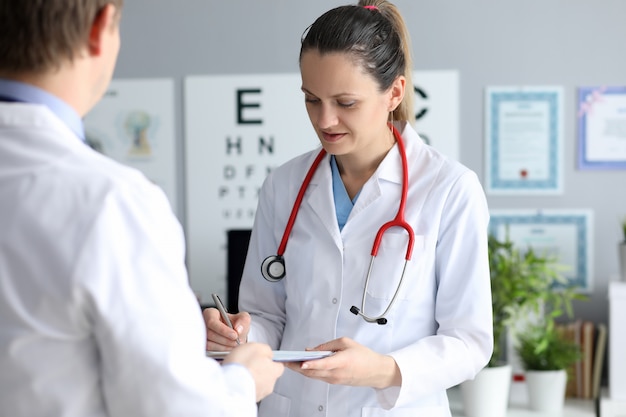 Female doctor hold silver pen in hand 