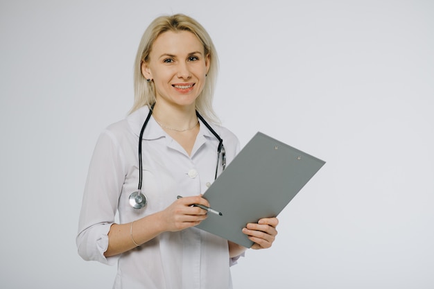 Female doctor holding a clipboard isolated over a white