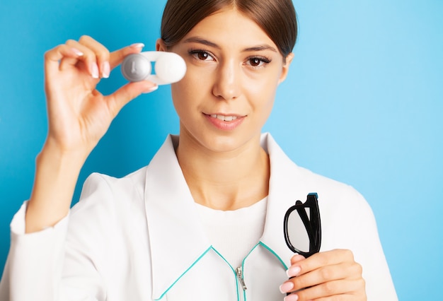 Female doctor holding a container with optical lenses