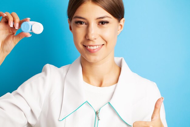 Female doctor holding a container with optical lenses