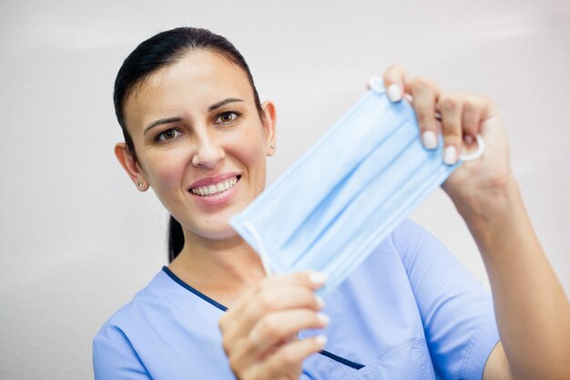 Female doctor holding a medical mask