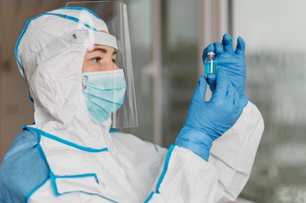 Female doctor holding a vaccine bottle