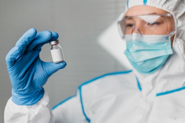 Female doctor holding a vaccine bottle