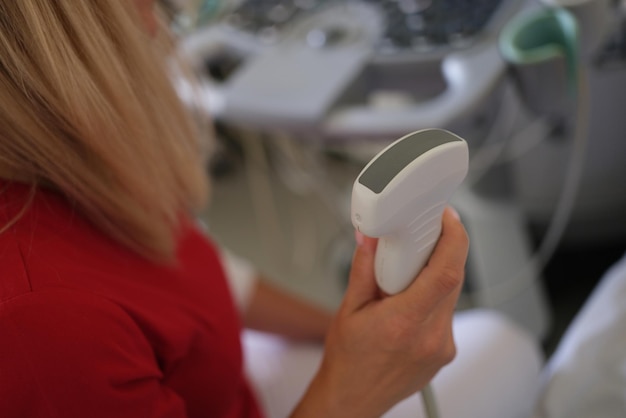 Female doctor holds ultrasound scanner device for examining patient in her hand ultrasound