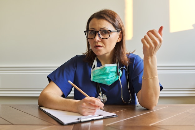 Female doctor looking at webcam