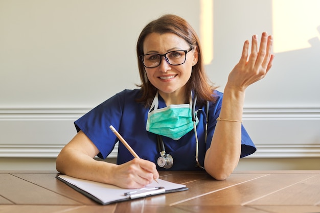 Female doctor looking at webcam