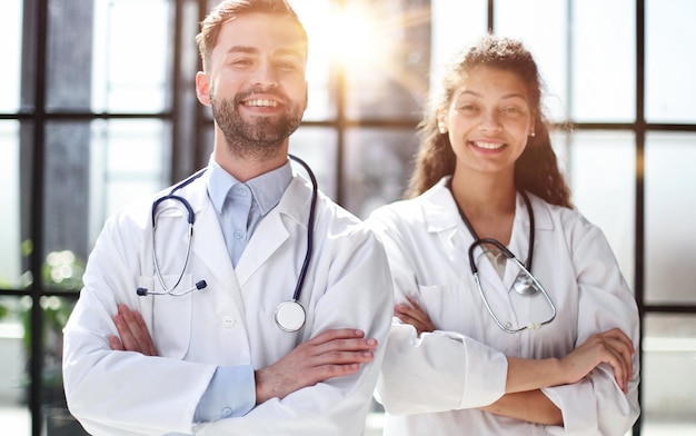 female doctor and male doctor stand in the lobby of the hospital