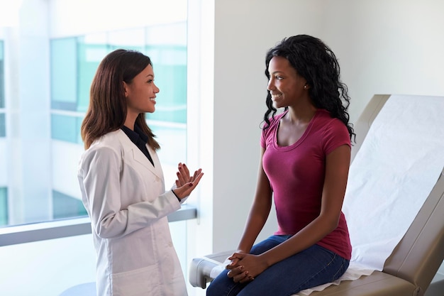 Female Doctor Meeting With Patient In Exam Room