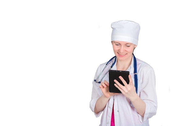 Female doctor or nurse with a stethoscope uses a tablet Isolated on white background copyspace