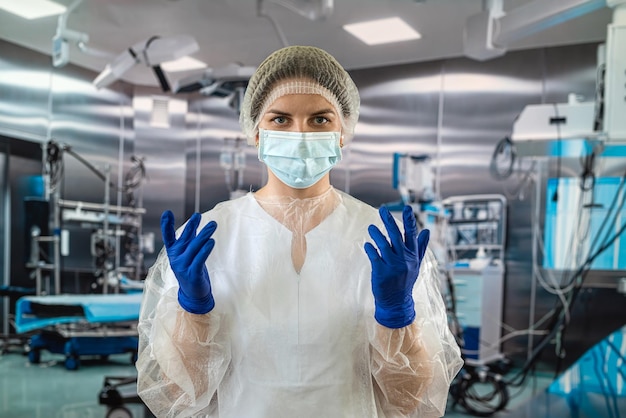 Female doctor in the operating room in a special uniform injecting medicine through the patient concepts of surgery operating room medicine doctor