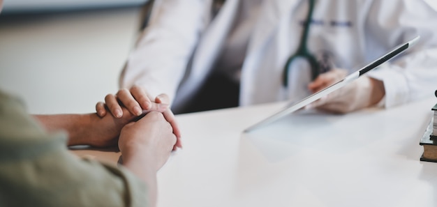 female doctor patient hand for encouragement and empathy