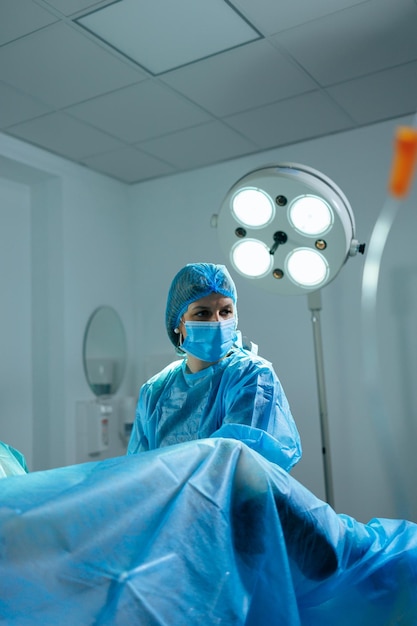 A female doctor performs an operation in a sterile operating room Surgical intervention operation Doctor in sterile clothes